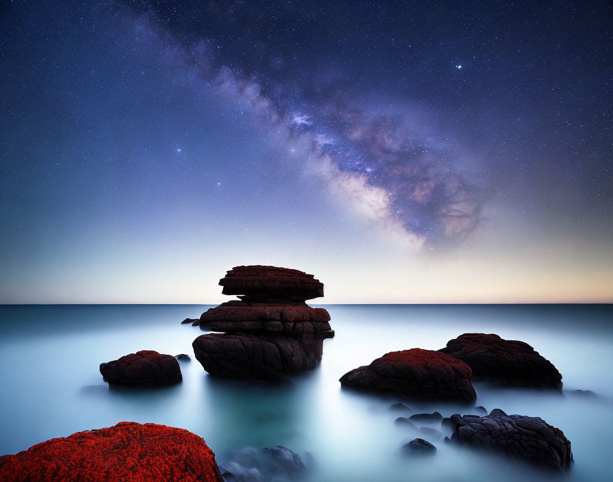 Tranquil Nightscape: Milky Way over Misty Waters & Moss-Covered Rocks