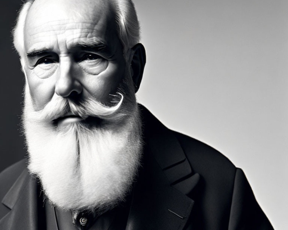 Monochrome portrait of elderly man with white beard and suit