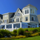 Charming white houses with blooming balconies in lush garden setting