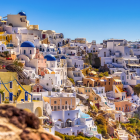 Colorful village with terracotta-roofed houses in lush setting