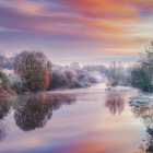 Colorful landscape painting: sunset sky, water reflection, blooming trees, calm river