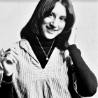 Monochrome portrait of a smiling woman with vintage hairstyle and cigarette