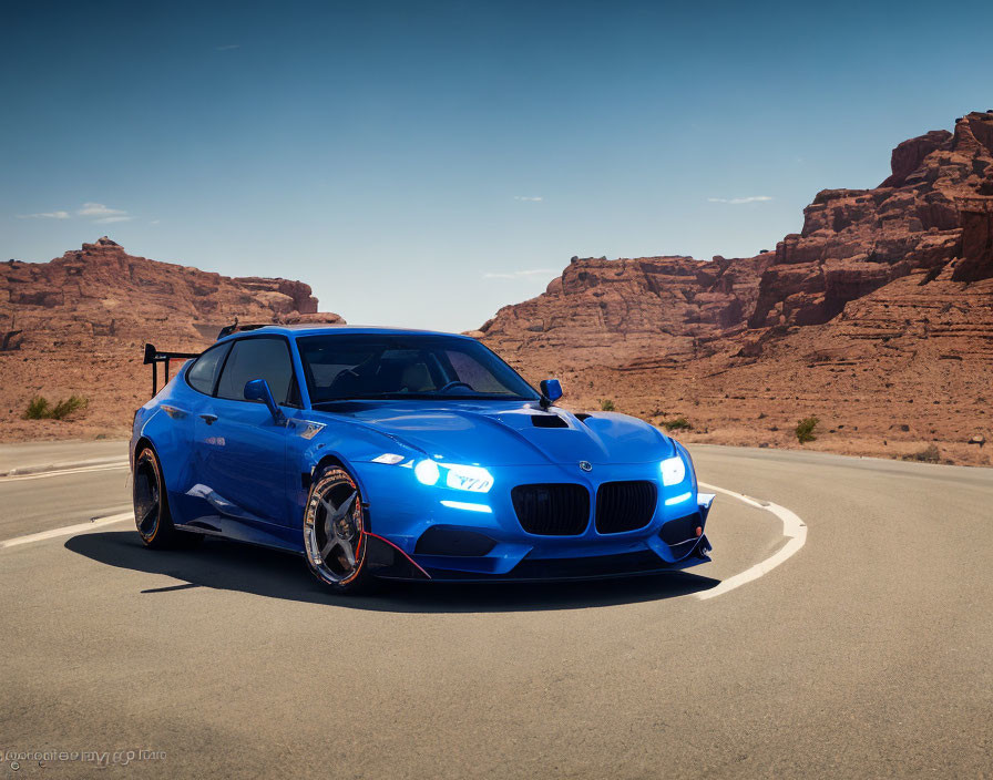 Blue sports car on asphalt road in rocky desert landscape