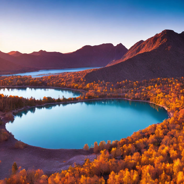 Tranquil Blue Lake with Autumn Foliage and Mountain Sunset