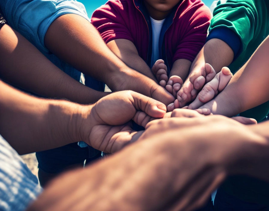 Diverse group showing unity and teamwork outdoors