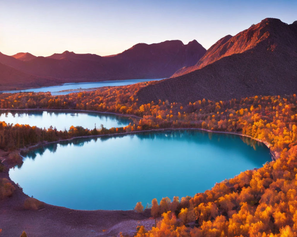 Tranquil Blue Lake with Autumn Foliage and Mountain Sunset