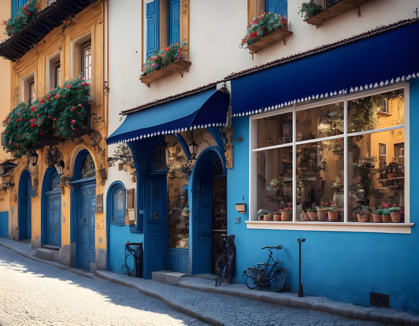 Charming street scene with blue facade, flowerpots, bicycle, and traditional architecture