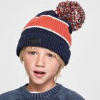 Young child with freckles in striped beanie with pompom.