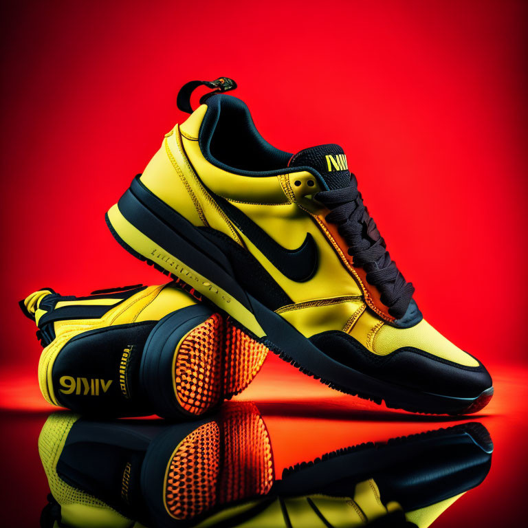 Yellow and Black Sneakers with Visible Logo on Reflective Surface Against Red Background