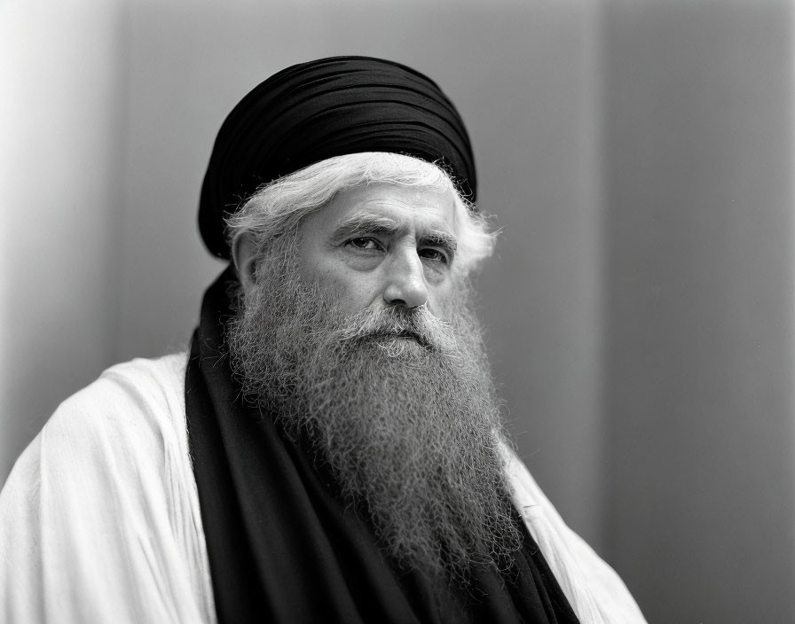 Man with White Beard in Black Turban and White Garment, Contemplative Expression