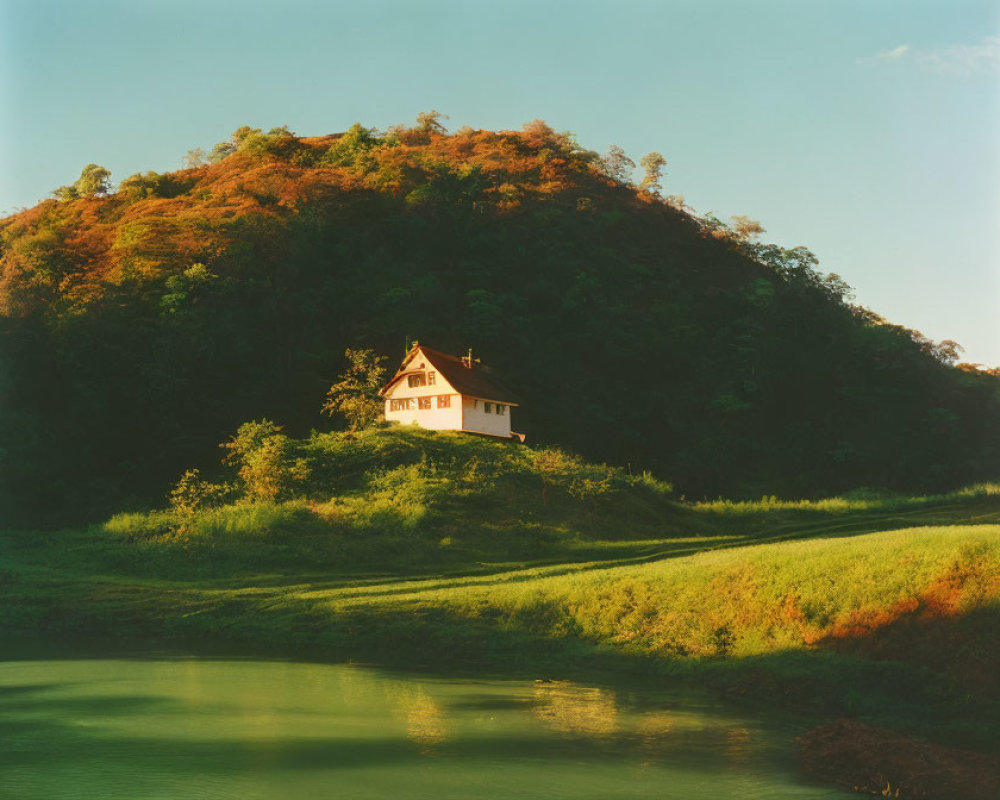 White House with Brown Roof in Autumn Landscape under Blue Sky