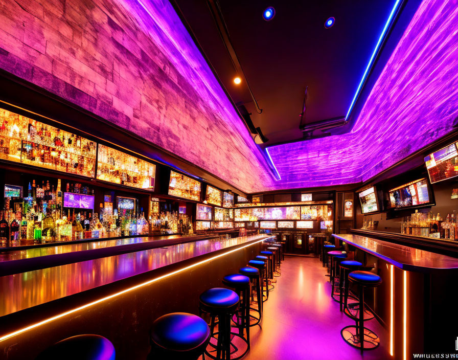 Bar with Purple Neon Lighting, Liquor Bottles, Bar Stools, and TV Screens