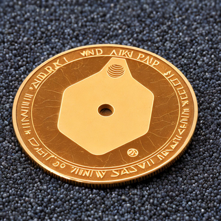 Intricate golden coin with hole on dark textured background