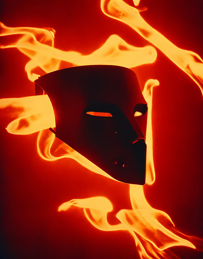 Enigmatic mask against fiery red backdrop with dynamic flame patterns