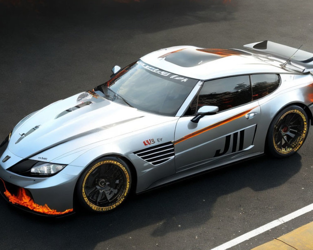 Silver sports car with black and orange flame decals and number 11 parked on asphalt with trailing flames