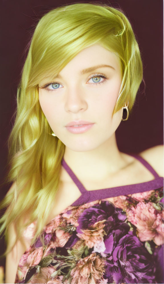 Blonde woman in floral outfit against dark background