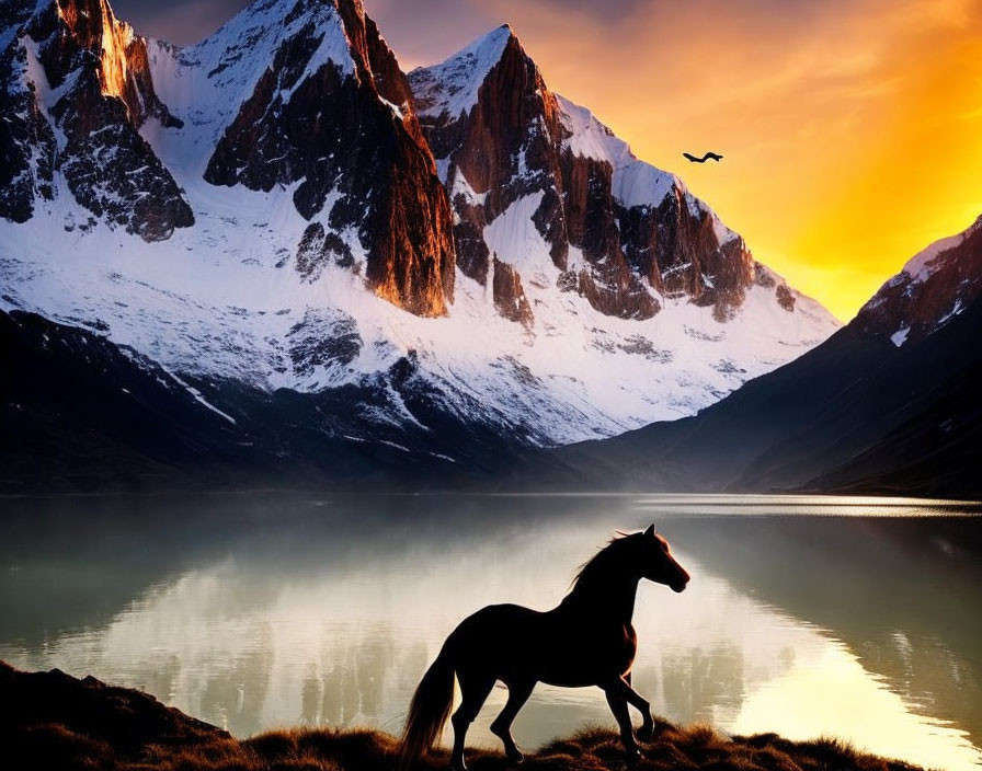 Horse galloping by tranquil lake with snowy mountains and glowing sunset sky