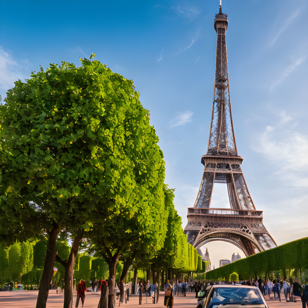 Iconic Eiffel Tower with lush greenery and people walking below