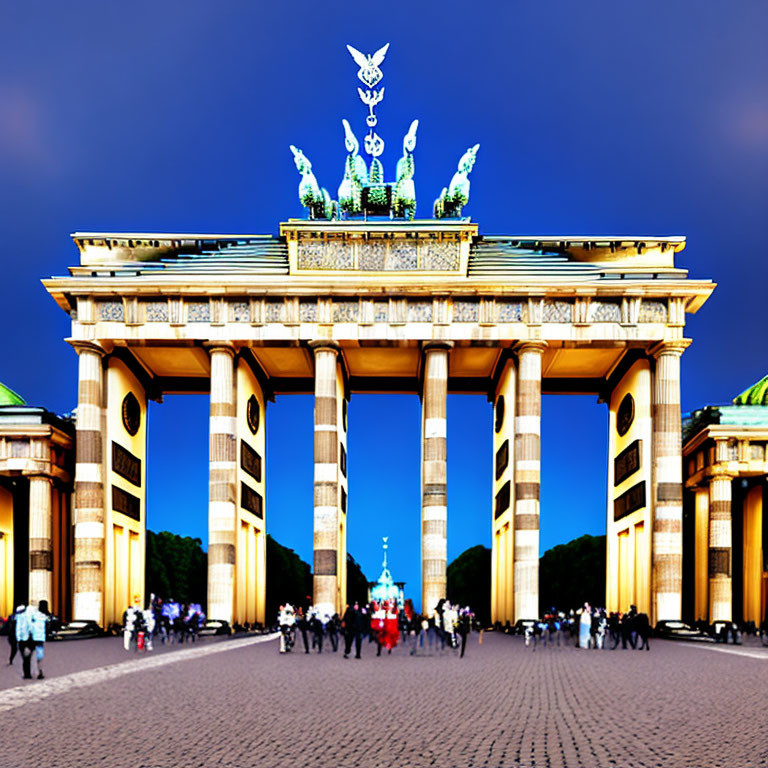 Twilight view of Brandenburg Gate with illuminated plaza and statue.