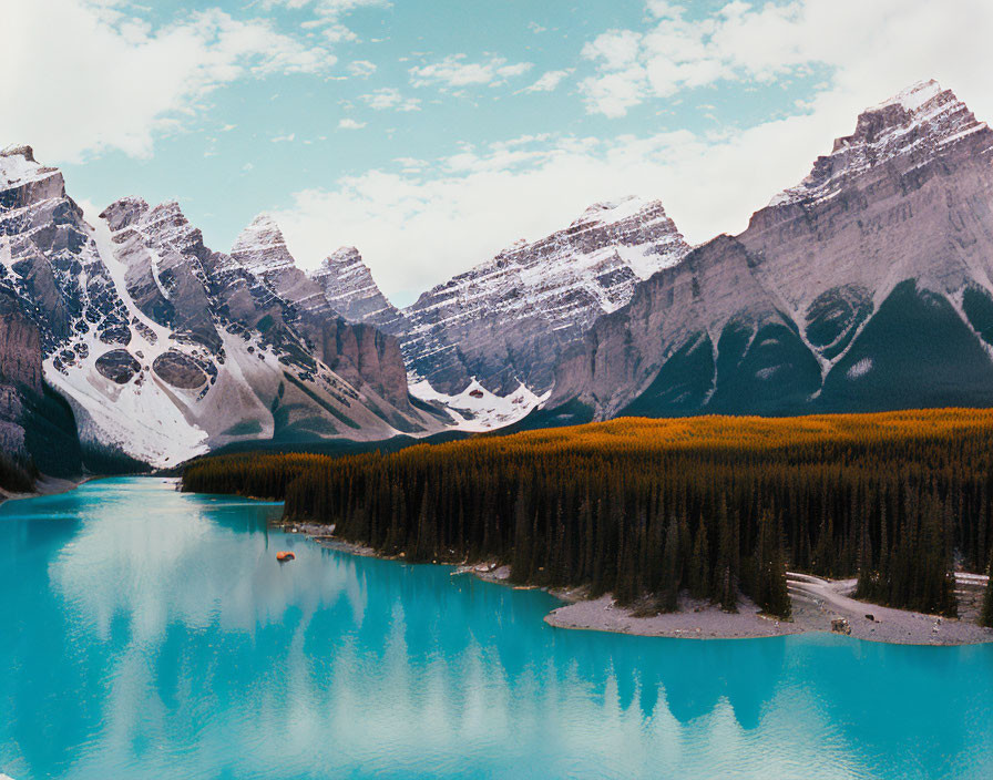 Serene Lake Surrounded by Snow-Capped Mountains and Forest