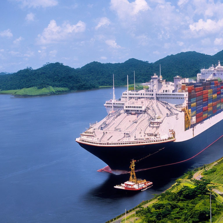 Cargo ship with containers sailing between green hills on waterway