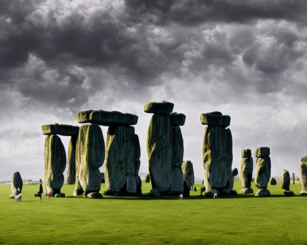 Ancient Stonehenge with Visitors on Green Field under Dramatic Sky