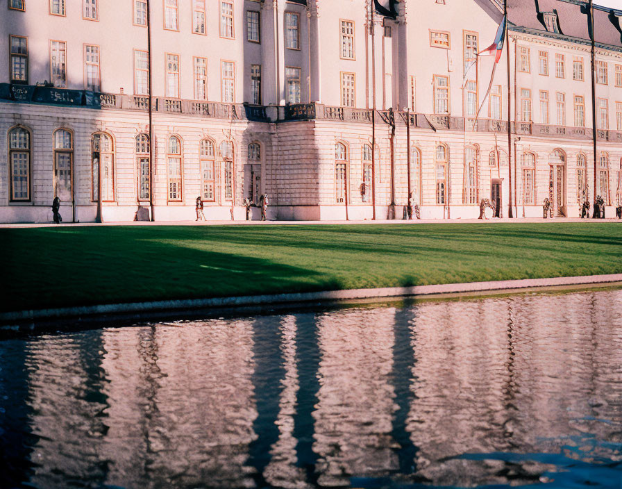 Classic Architecture Building by Reflective Pond on Sunny Day