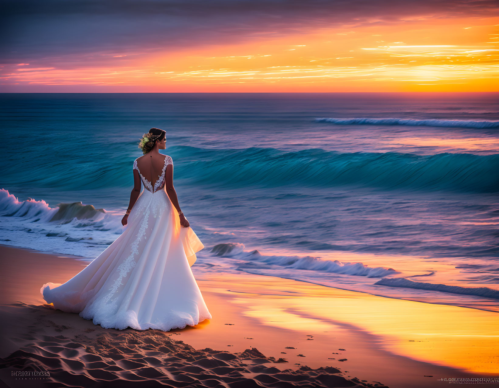 Bride in white gown on beach at sunset gazes at vibrant sky and sea