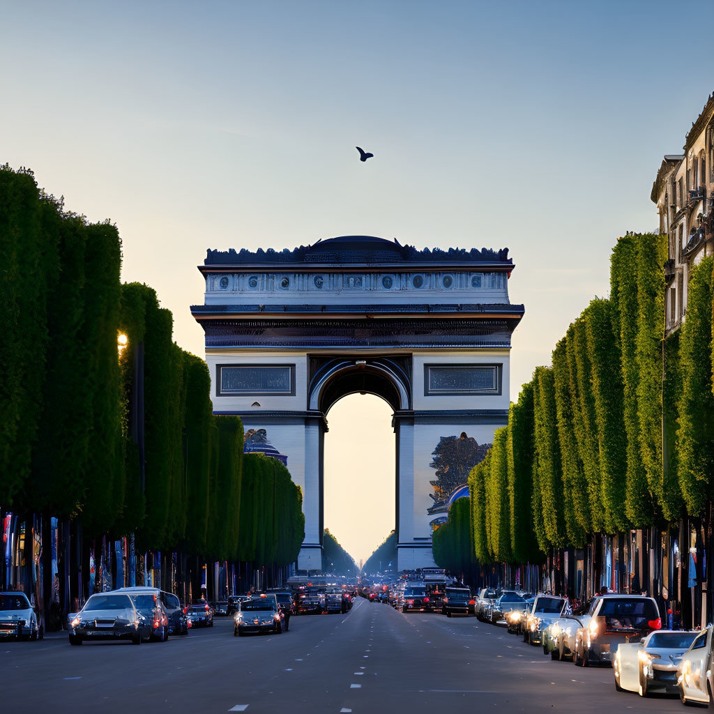 Iconic Arc de Triomphe in Paris at dusk with traffic and trees