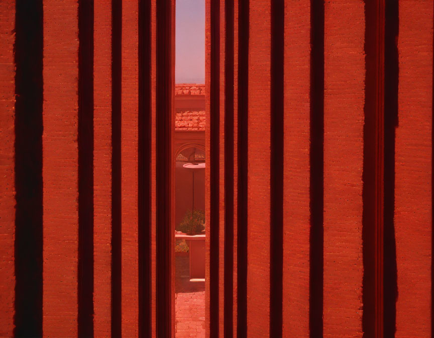 Brick wall with vertical gaps showing building window