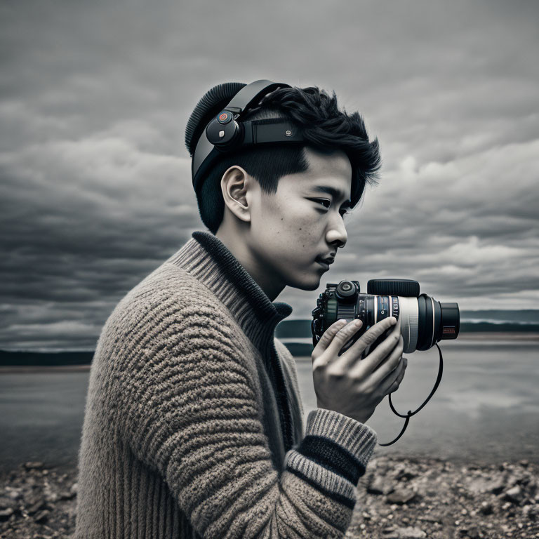 Photographer with headphones captures shot under dramatic sky.