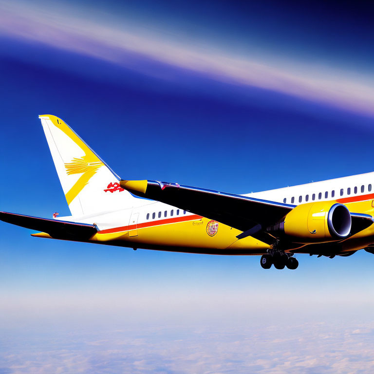 Yellow and white commercial airplane with sun logo flying high in clear skies