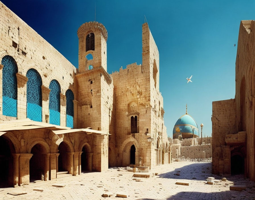 Ancient stone architecture with arched doorways, tower, and dome under clear blue sky