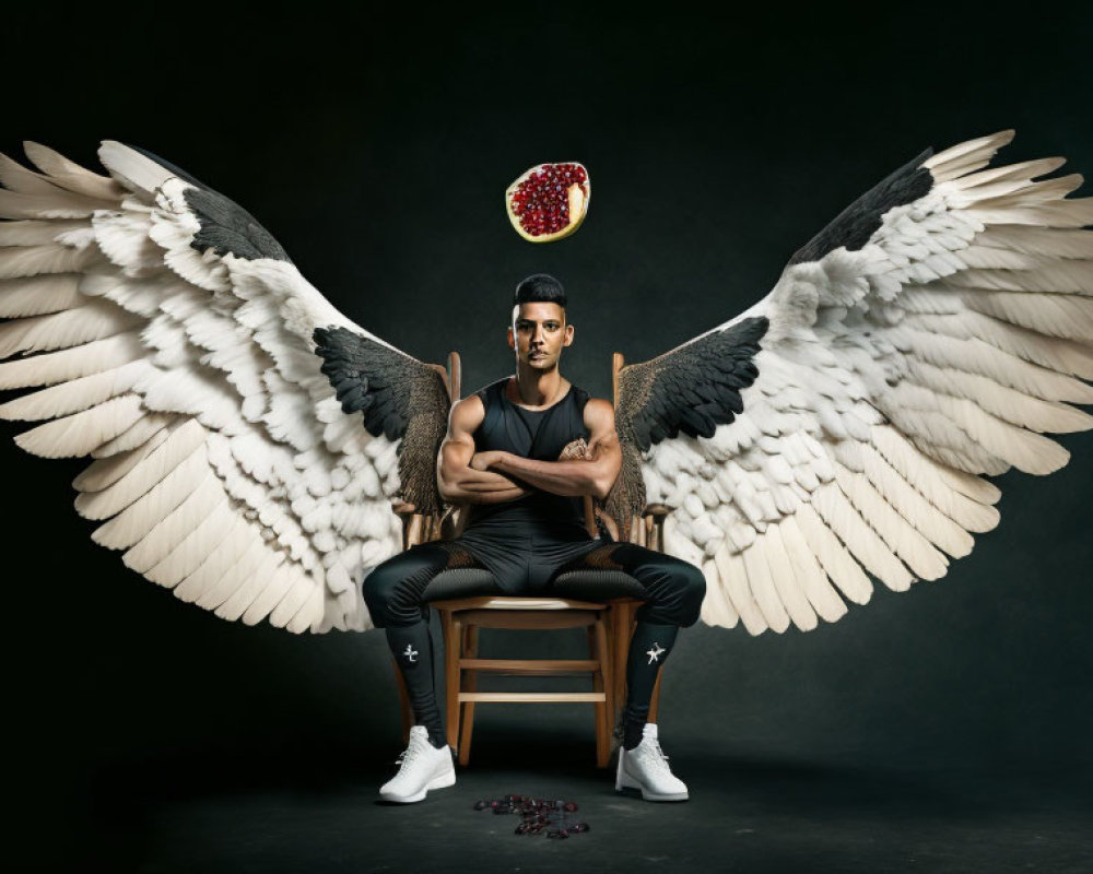 Man with white wings and pomegranate halo on chair against dark backdrop