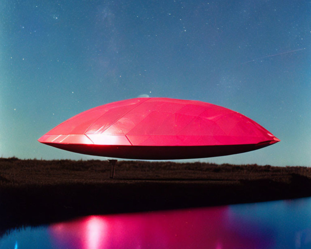 Red UFO-shaped object hovers over serene landscape at night