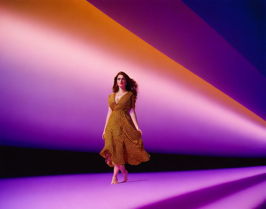 Woman in Polka Dot Dress on Purple Floor with Violet and Orange Background