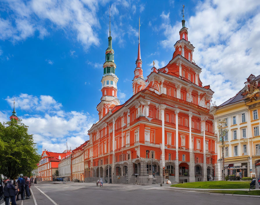 Baroque-style red building with green spires in classic architecture scene