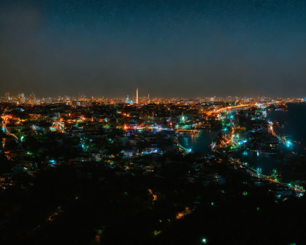 Bright cityscape with star-filled sky over illuminated urban area.