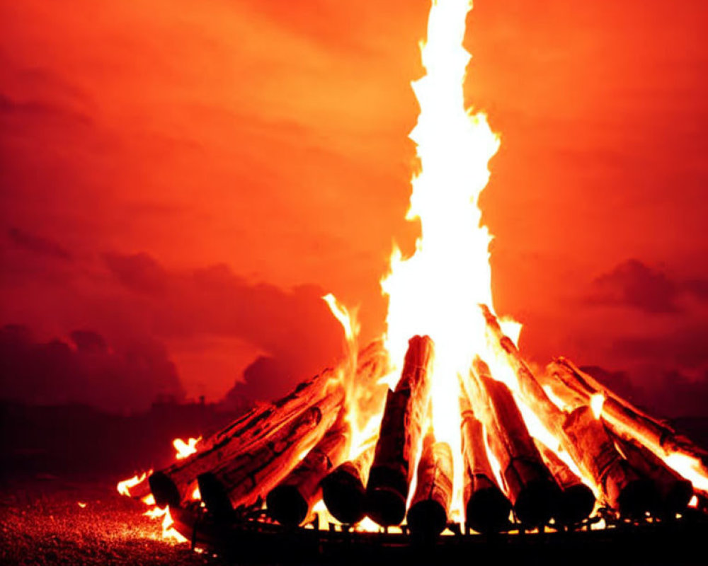 Intense Flames and Glowing Embers in Large Bonfire at Dusk