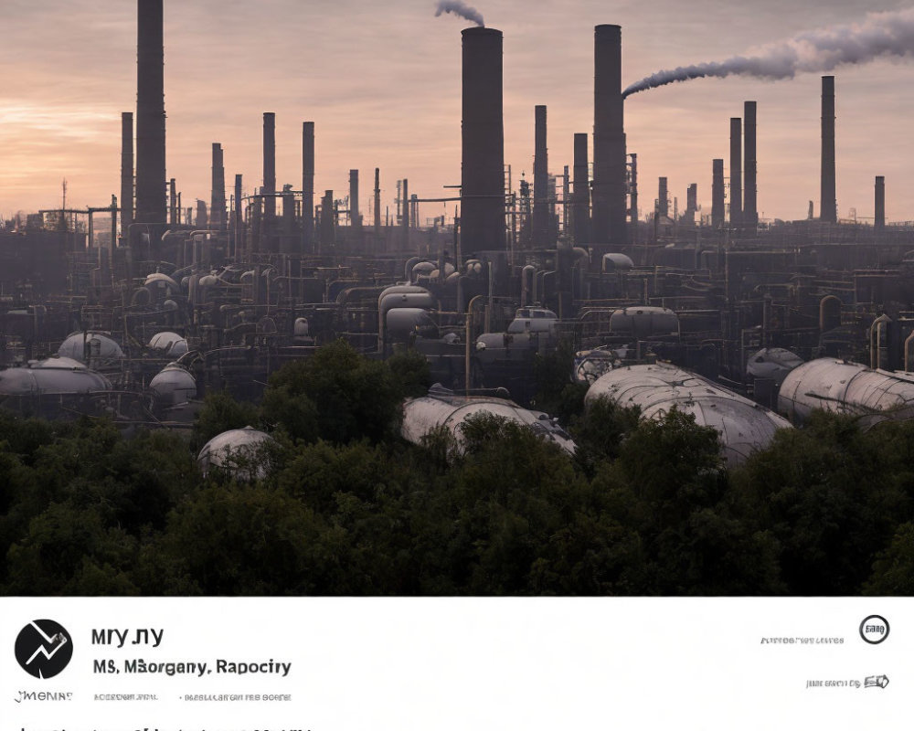 Industrial complex with smoke-emitting chimneys and storage tanks under dusky sky