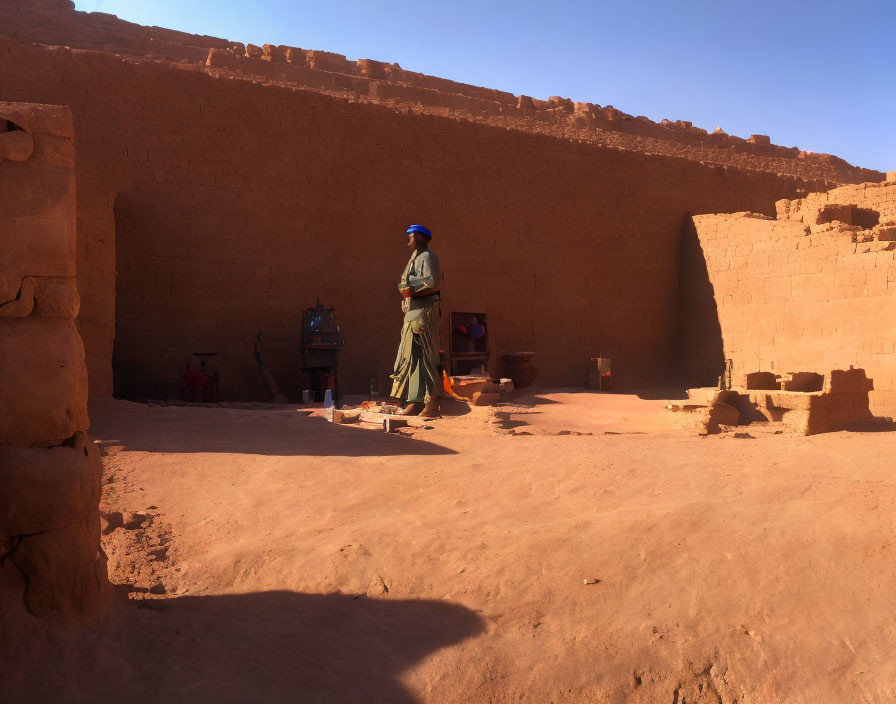 Traditional Attire Person with Clay Pottery in Ancient Earthen Structure