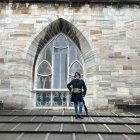 Knight in shining armor on cathedral roof under clear sky