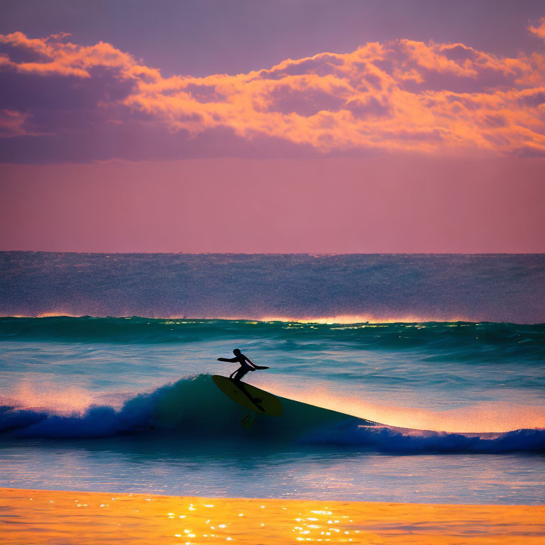 Surfer catching wave at vibrant purple and orange sunrise/sunset