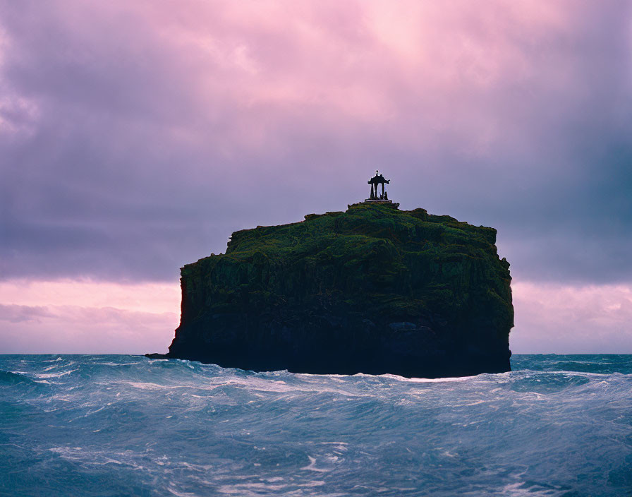 Camera on Tripod Capturing Isolated Sea Stack at Dusk