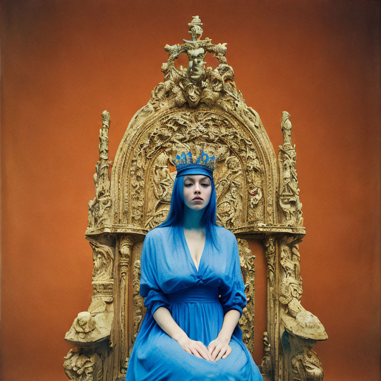 Woman in Blue Dress and Crown on Golden Throne Against Orange Backdrop