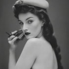 Vintage black and white photo of woman with hat and cigarette holder