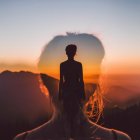 Silhouette of two women against sunrise backdrop