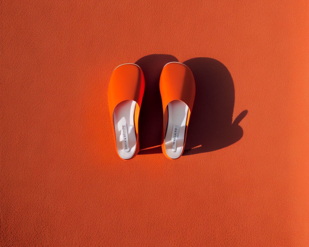 Orange Slides on Textured Surface with Sunlight Shadows