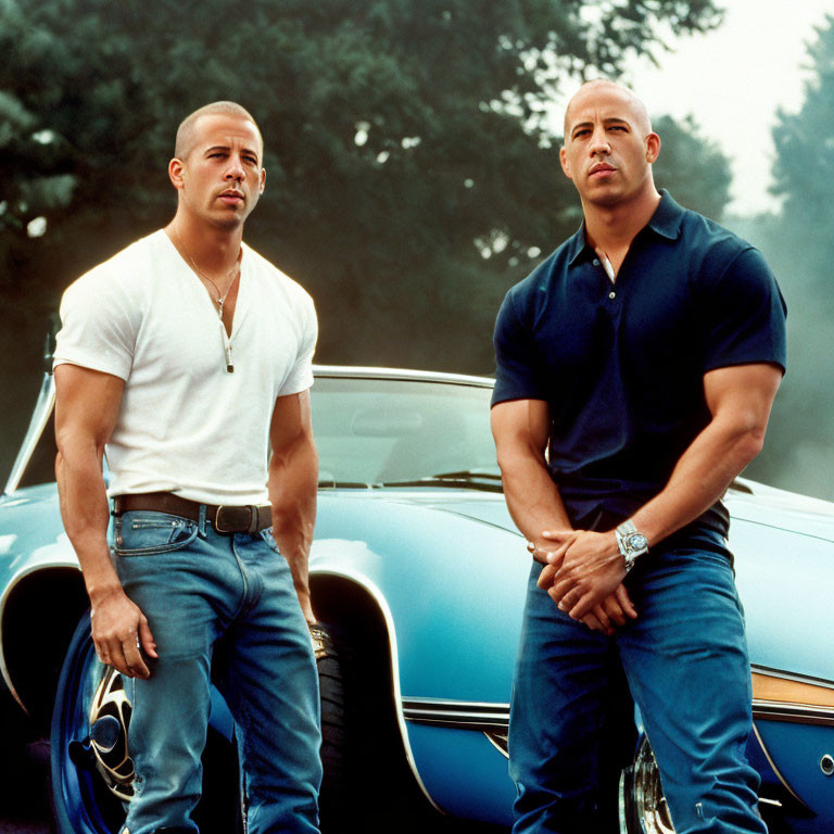 Muscular men in white and blue shirts pose by classic car