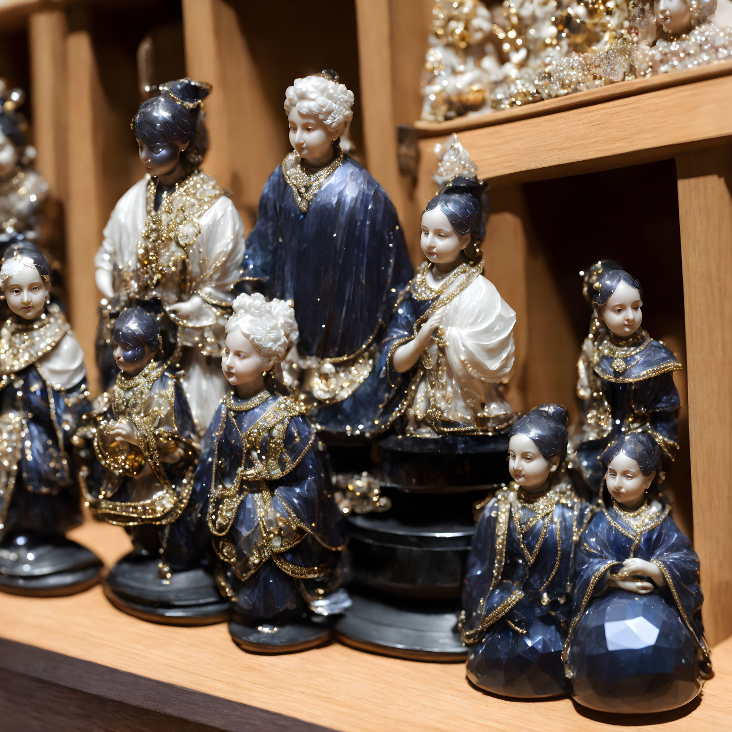 Intricate porcelain figurines in historical outfits on wooden shelf